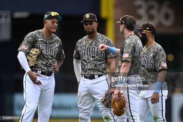 San Diego Padres players talk during a baseball game against the Tampa Bay Rays at Petco Park on June 18, 2023 in San Diego, California.