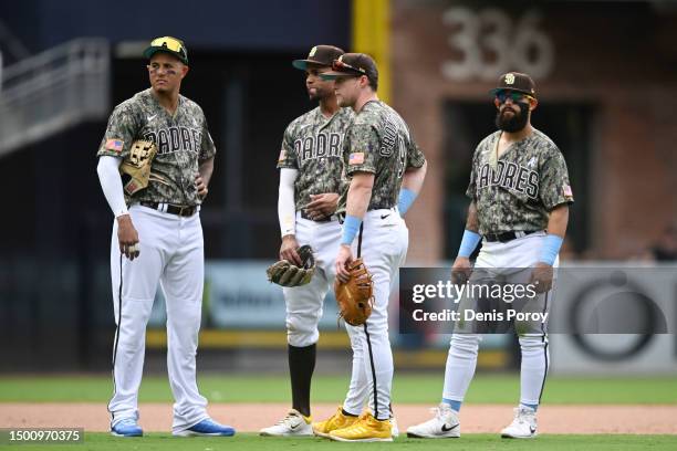 San Diego Padres players talk during a baseball game against the Tampa Bay Rays at Petco Park on June 18, 2023 in San Diego, California.