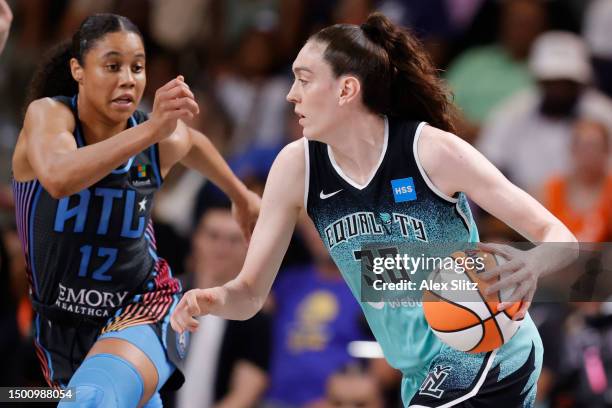 Breanna Stewart of the New York Liberty dribbles past Nia Coffey of the Atlanta Dream during the first half at Gateway Center Arena on June 23, 2023...