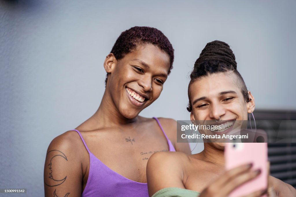Transgender woman friends making selfie