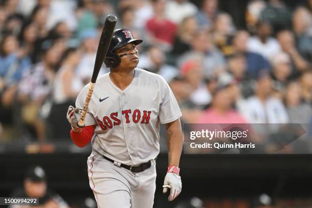 Rafael Devers of the Boston Red Sox tosses his bat after hitting a two-run home run in the fourth inning against the Chicago White Sox at Guaranteed...