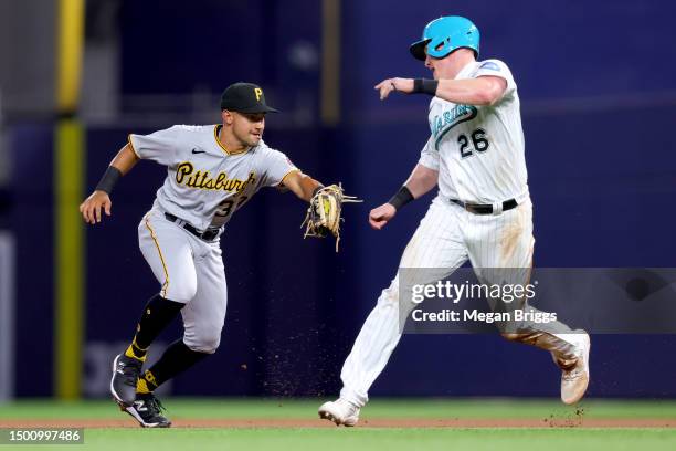 Nick Gonzalez of the Pittsburgh Pirates tags out Garrett Cooper of the Miami Marlins during the fourth inning at loanDepot park on June 23, 2023 in...