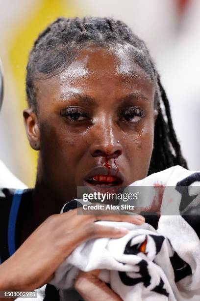 Laeticia Amihere of the Atlanta Dream is tended to by medical staff after a flagrant foul from Stefanie Dolson of the New York Liberty during the...