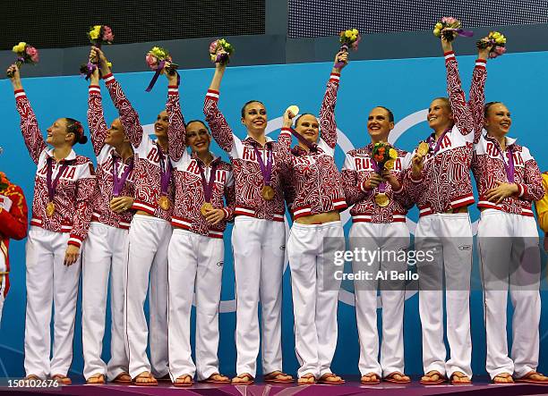 Gold medallists Russia celebrate on the podium during the medal ceremony for the Women's Teams Synchronised Swimming Free Routine final on Day 14 of...