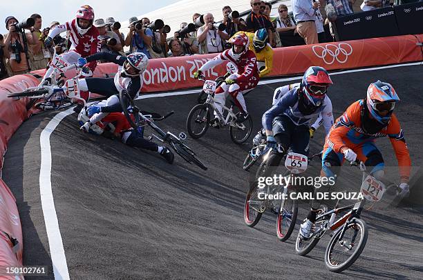 Netherlands' Raymon van der Biezen and Britain's Liam Phillips ride on as France's Quentin Caleyron, US BMX cyclist Connor Fields, Latvia's Edzus...