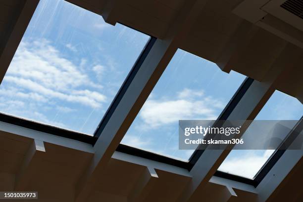 the rooftop window for lighting comes through  with blue sky - skylight stock pictures, royalty-free photos & images