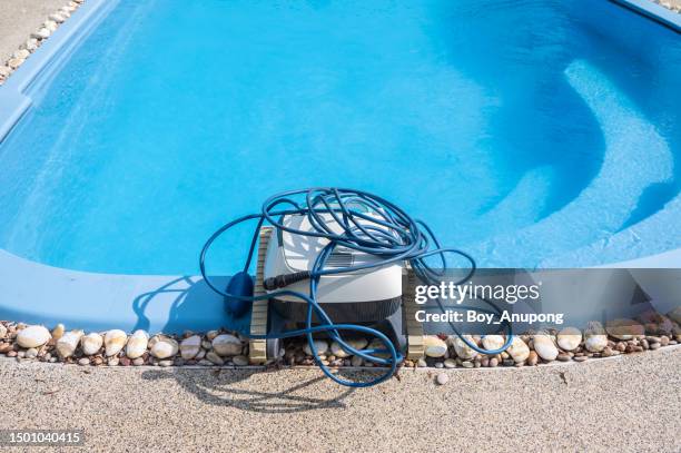 a robotic pool cleaner preparation at the poolside before using it. - pool cleaner stock pictures, royalty-free photos & images