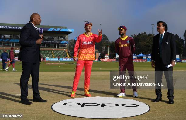 Craig Ervine of Zimbabwe flips the coin as Shai Hope of West Indies looks on ahead of the ICC Men's Cricket World Cup Qualifier Zimbabwe 2023 match...