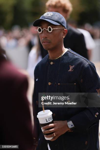 Pharrell Williams is seen wearing a Louis Vuitton denim set, Louis Vuitton cup, Tiffany & Co diamond shades and Louis Vuitton yellow croco leather...