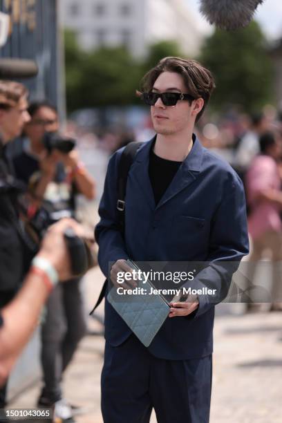 Sebastien Frit is seen wearing a navy blue matching suit and black shirt outside Dior Homme during the Menswear Spring/Summer 2024 as part of Paris...