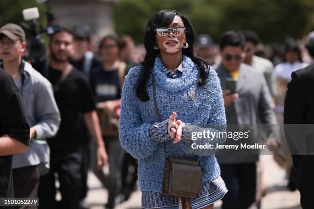 Winnie Harlow is seen wearing a blue mesh turtleneck sweater, Dior monogram baby blue brown flanell and silk shorts outside Dior Homme during the...