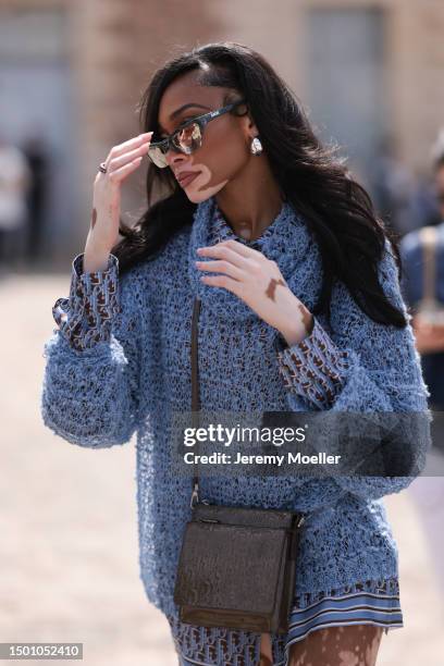 Winnie Harlow is seen wearing a blue mesh turtleneck sweater, Dior monogram baby blue brown flanell and silk shorts outside Dior Homme during the...