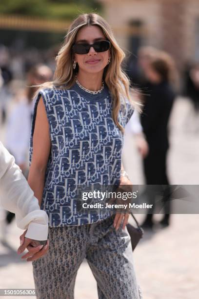 Valentina Ferrer is seen wearing a Dior monogram blue and white knit vest, Dior Saddle bag, Dior white sneaker, Dior monogramm wide leg pants and...