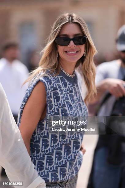 Valentina Ferrer is seen wearing a Dior monogram blue and white knit vest, Dior Saddle bag, Dior white sneaker, Dior monogramm wide leg pants and...