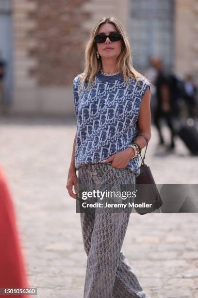 Valentina Ferrer is seen wearing a Dior monogram blue and white knit vest, Dior Saddle bag, Dior white sneaker, Dior monogramm wide leg pants and...