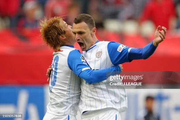 Milivoje Novakovic of Shimizu S-Pulse celebrates with teammate Genki Omae after scoring the team's first goal during the J.League J1 match between...