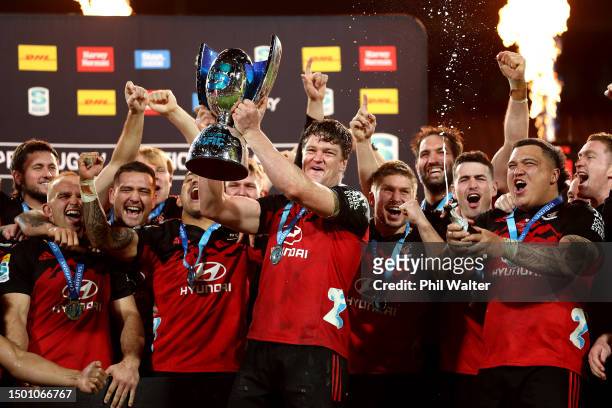 Scott Barrett holds the Super Rugby Pacific trophy as the Crusaders celebrate after winning the Super Rugby Pacific Final match between Chiefs and...