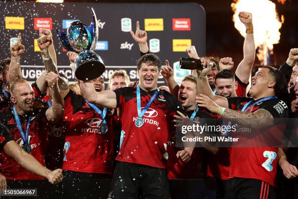 Scott Barrett holds the Super Rugby Pacific trophy as the Crusaders celebrate after winning the Super Rugby Pacific Final match between Chiefs and...