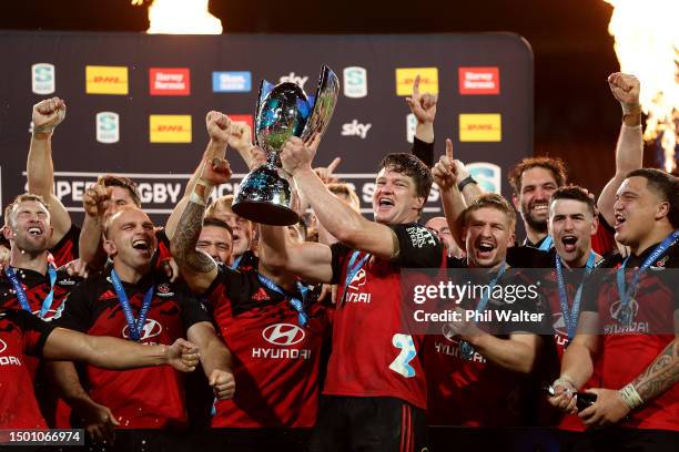 Scott Barrett holds the Super Rugby Pacific trophy as the Crusaders celebrate after winning the Super Rugby Pacific Final match between Chiefs and...