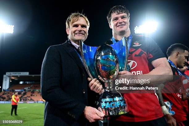 Coach Scott Robertson of the Crusaders and Scott Barrett of the Crusaders pose for a photo with the Super Rugby Pacific trophy following the Super...