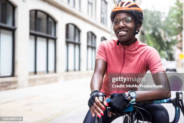 portrait of young female cyclist in urban environment - pink hard hat stock pictures, royalty-free photos & images