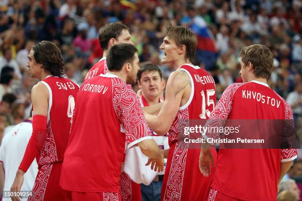 Andrey Kirilenko of Russia reacts with teammates Timofey Mozgov and Evgeny Voronov while taking on Spain during the Men's Basketball semifinal match...