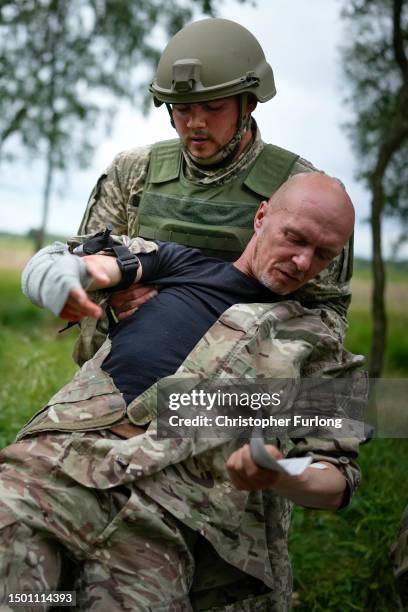 Ukrainian combat medic Sasha administers first aid to an exercise casualty during the first combat medical training course in the UK to Ukrainian...