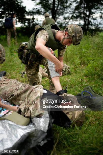 Ukrainian combat medic Mike administers first aid to an exercise casualty during the first combat medical training course in the UK to Ukrainian...