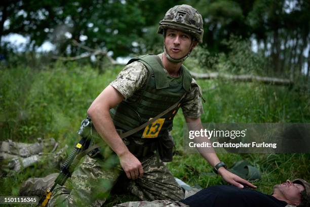 Ukrainian combat medic Mike administers first aid to an exercise casualty during the first combat medical training course in the UK to Ukrainian...