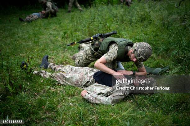 Ukrainian combat medic Mike administers first aid to an exercise casualty during the first combat medical training course in the UK to Ukrainian...