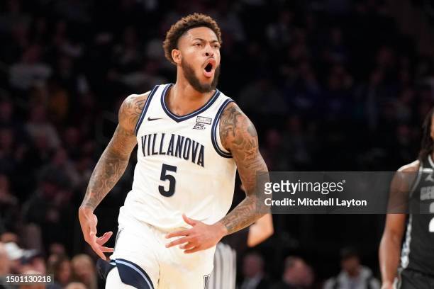 Justin Moore of the Villanova Wildcats celebrates a shot during the first round of the Big East Basketball Tournament against the Georgetown Hoyas at...