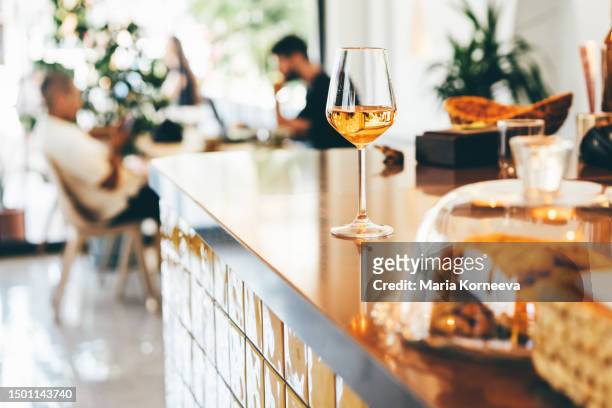a glass of wine on the bar counter in a cafe. - appetiser stock pictures, royalty-free photos & images