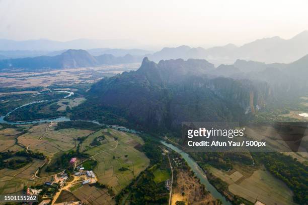 high angle view of landscape against sky,vang vieng,laos - vang vieng balloon stock pictures, royalty-free photos & images