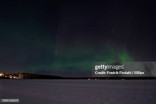 scenic view of landscape against sky at night,sweden - väder stock pictures, royalty-free photos & images