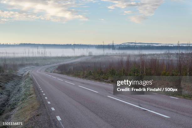 empty road amidst field against sky,sweden - sverige landskap stock pictures, royalty-free photos & images