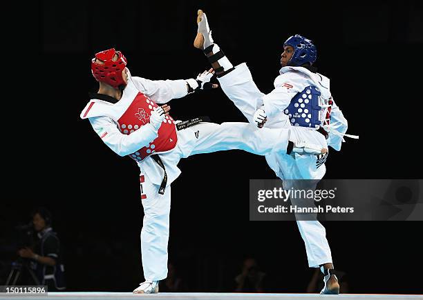 Yousef Karami of Islamic Republic of Iran competes against Lutalo Muhammad of Great Britain in the Men's -80kg Taekwondo Repechage bout on Day 14 of...