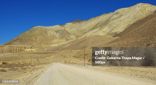 scenic view of road by mountains against clear blue sky,nepal - nepal road bildbanksfoton och bilder