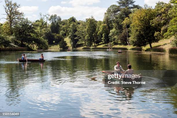 Guests enjoy the boating lake during Wilderness Festival at Cornbury Park on August 12, 2012 in Oxford, United Kingdom.