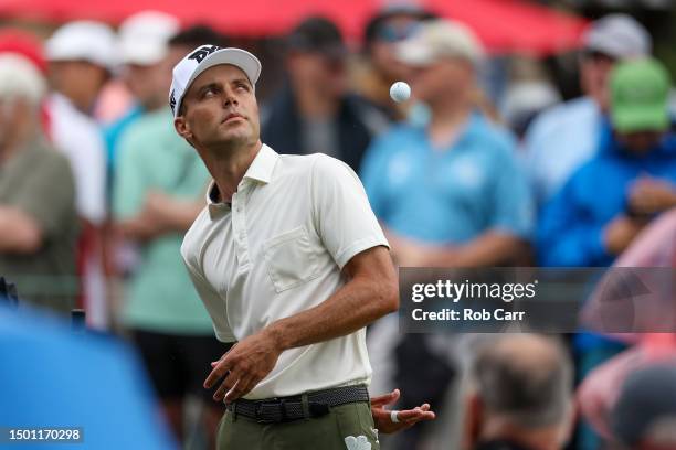 Eric Cole of the United States catches his golf ball behind his back before hitting his tee shot on the first hole during the third round of the...