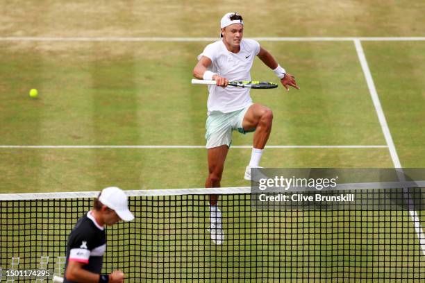 Holger Rune of Denmark jumps over the net against Alex De Minaur of Australia during the Men's Singles Semi-Final match on Day Six of the cinch...