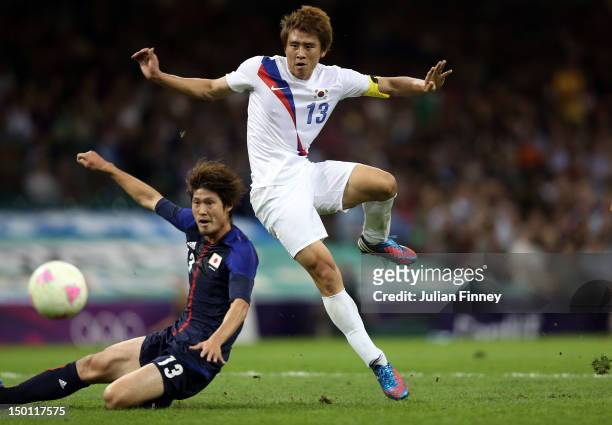 Jacheol Koo of Korea shoots and scores his teams second goal past Daisuke Suzuki of Japan during the Men's Football Bronze medal play-off match...