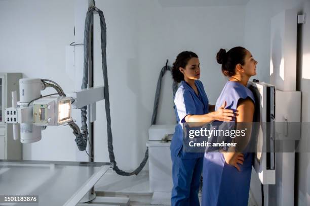 radiologist getting a patient ready for an x-ray - radiologist stock pictures, royalty-free photos & images