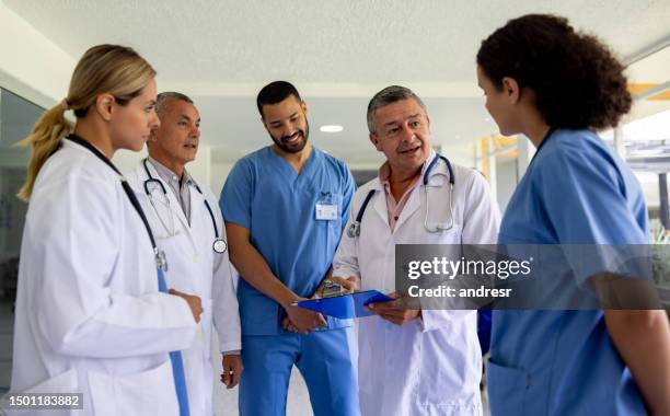 group of doctors talking in a staff meeting at the hospital - civil imagens e fotografias de stock