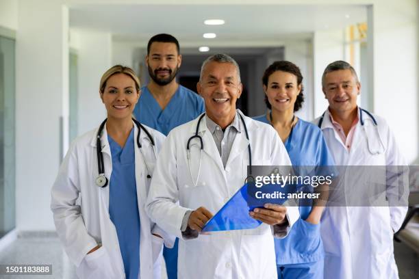happy group of doctors working at the hospital - civilian stock pictures, royalty-free photos & images