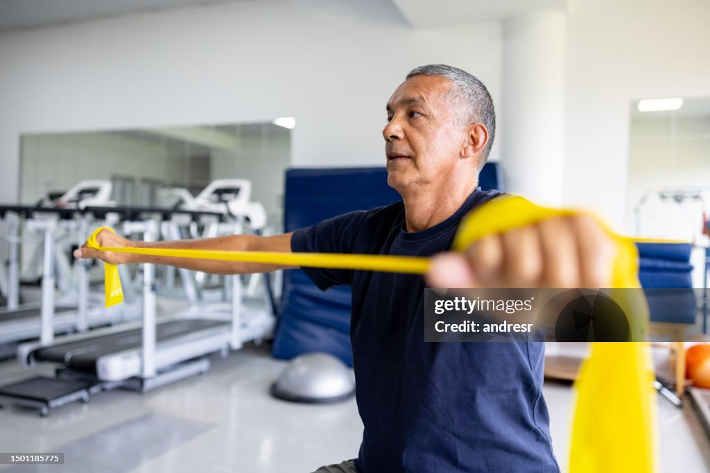 Man doing physical therapy exercises using a stretch band
