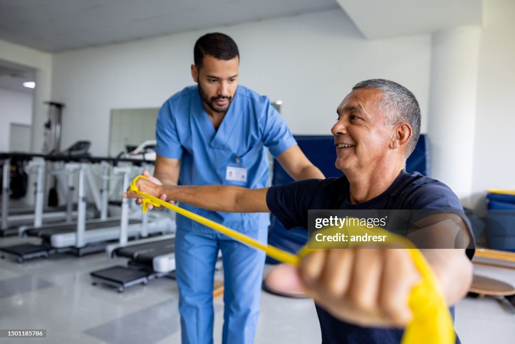 Man doing physical therapy exercises using a stretch band