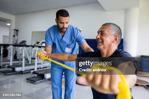 Man doing physical therapy exercises using a stretch band