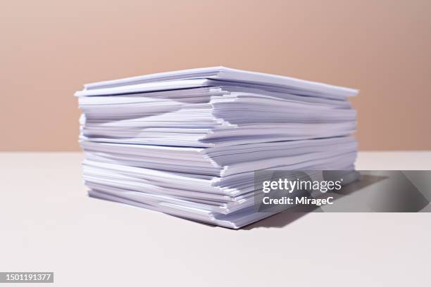 a heap of white paper on beige background - pile of paper stock pictures, royalty-free photos & images