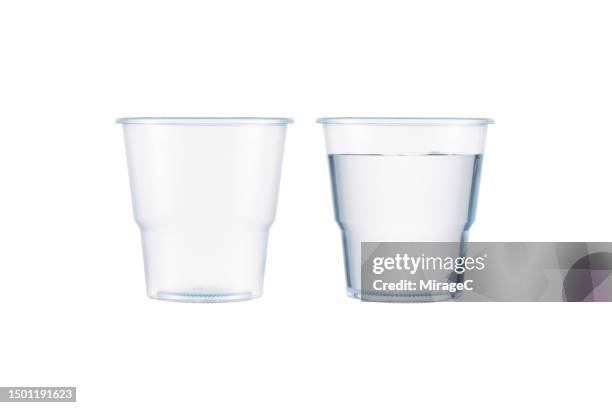 empty transparent plastic cup and full plastic cup of water isolated on white - bicchiere di carta foto e immagini stock