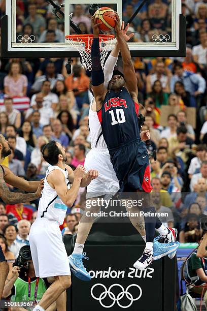 Kobe Bryant of United States dunks the ball over Andres Nocioni of Argentina in the first half during the Men's Basketball semifinal match on Day 14...